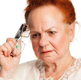 elderly woman holding eyeglasses